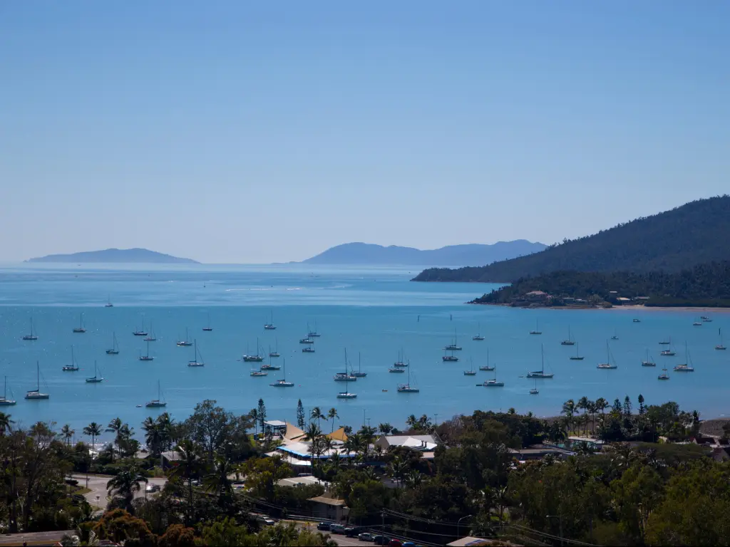 Dozens of boats on the clear blue water at the famous Airlie Beach Race Week in Australia on a sunny day