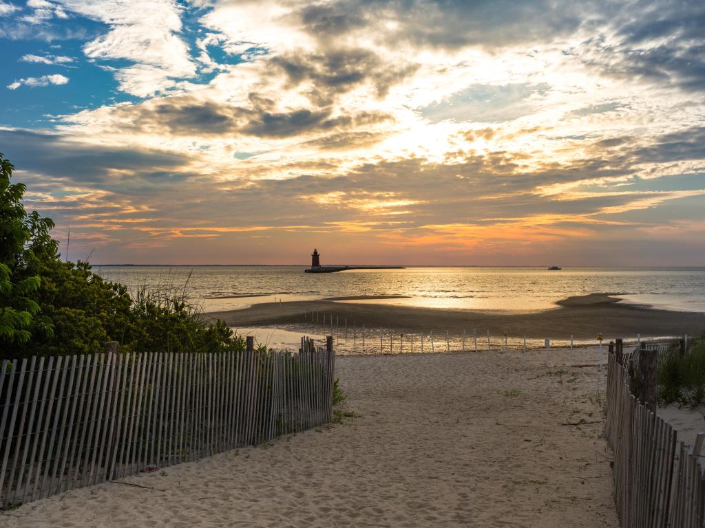 Cape Henlopen State Park, Lewes, Delaware, USA with a view of the Delaware Breakwater East End Lighthouse at sunset.
