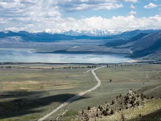 US-395 going past Mono Lake in California with the Sierra Nevada mountains in the background as seen from Conway Summit.