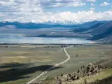 US-395 going past Mono Lake in California with the Sierra Nevada mountains in the background as seen from Conway Summit.