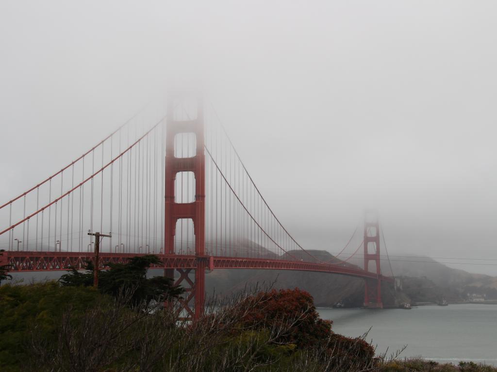 June Gloom in San Francisco with heavy fog setting on the city's Golden Gate Bridge