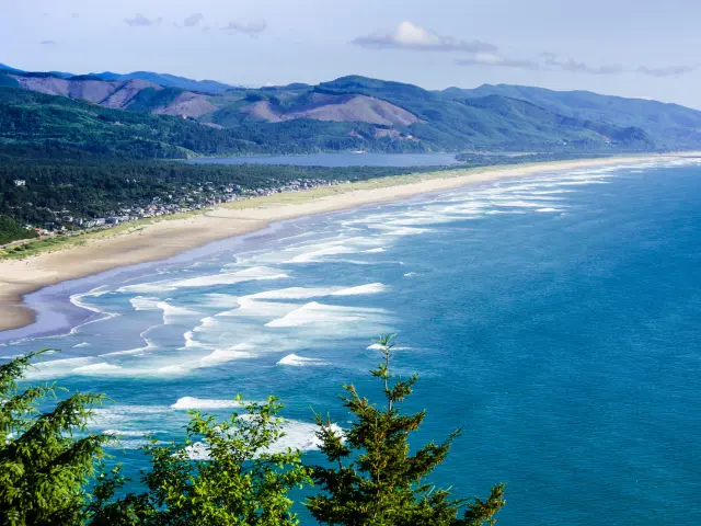 A panoramic shot of the white sandy beach at Rockaway Beach, part of a beautiful seven mile stretch of coastline