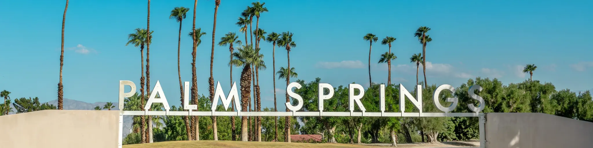 Palm Springs Welcome Sign with blue sky and palm trees
