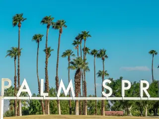 Palm Springs Welcome Sign with blue sky and palm trees