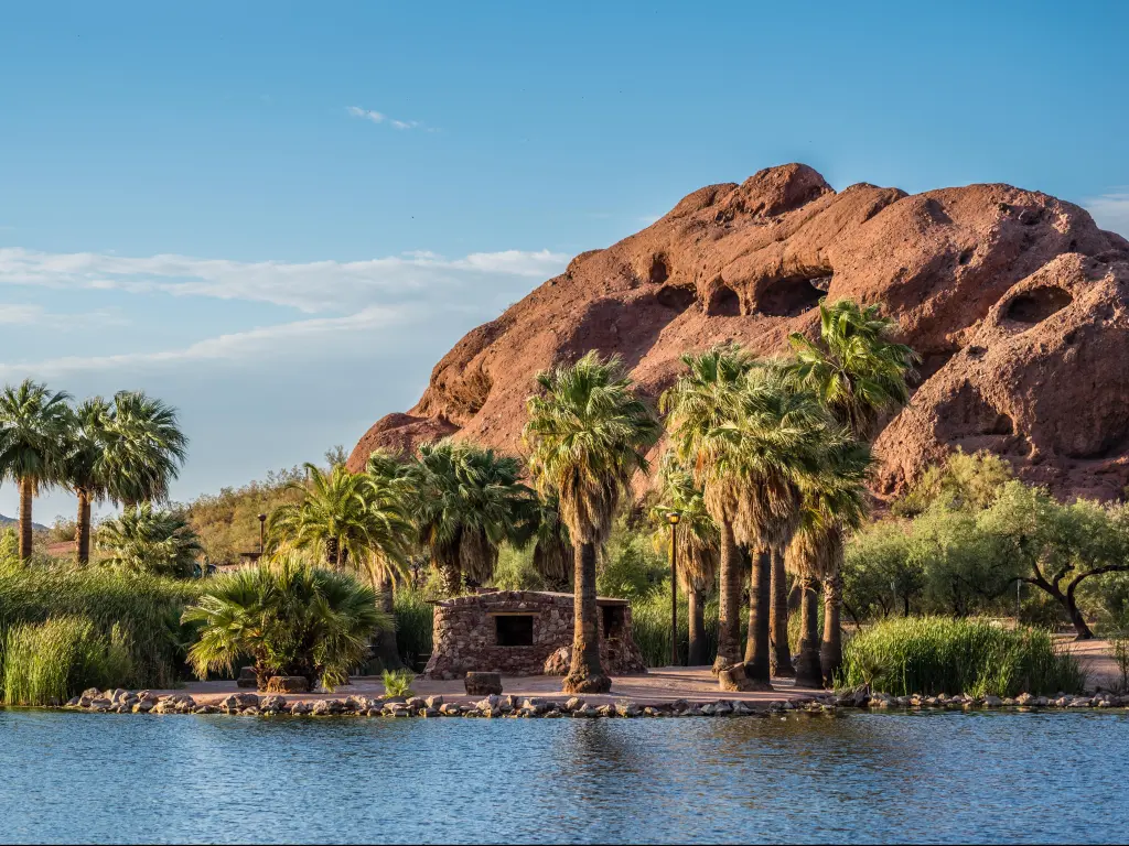 The Hole-in-the-Rock natural geological formation is visible from across one of Papago Park's ponds.