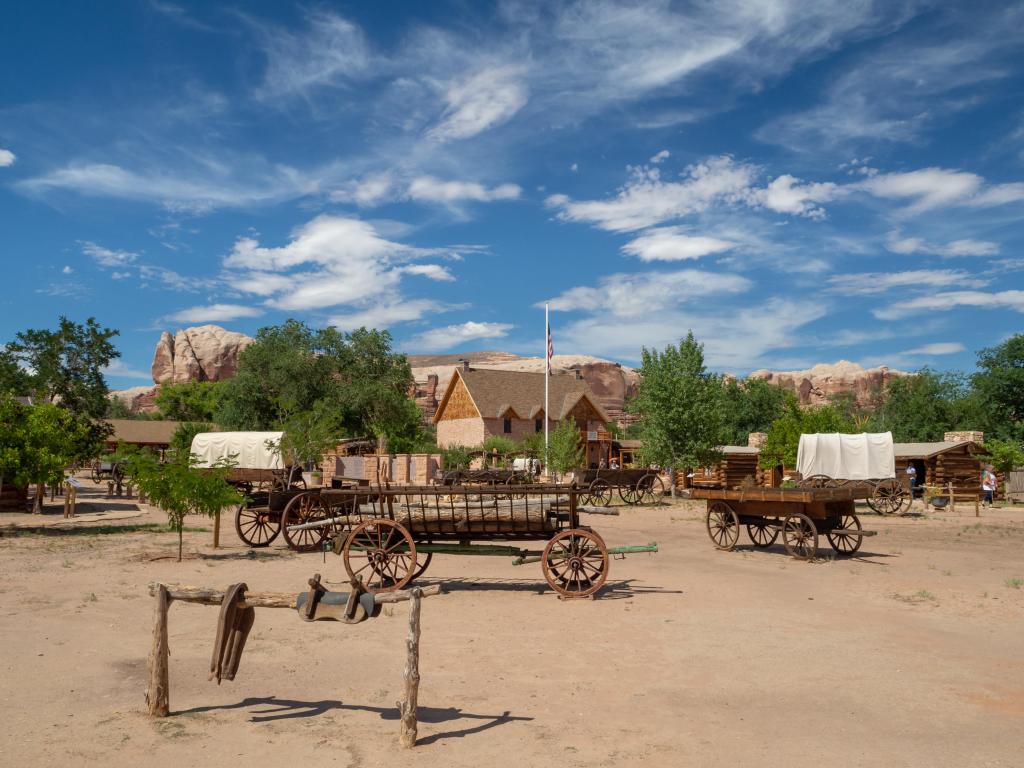 Cottages and wagons dotted across the desert at Bluff Fort Pioneer Historic Site 