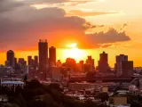 Fiery sunset behind the city's skyline, photo taken from a nearby hill