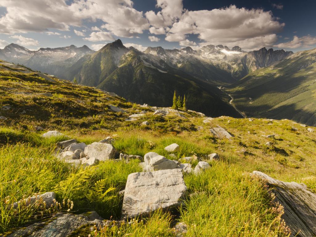 Glacier National Park, British Columbia, Canada with the amazing Rocky Mountains and view from Abbott Ridge on a cloudy but sunny day.