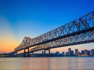 New Orleans, Louisiana, USA with the Crescent City Connection Bridge on the Mississippi river and downtown New Orleans Louisiana taken at sunset. 