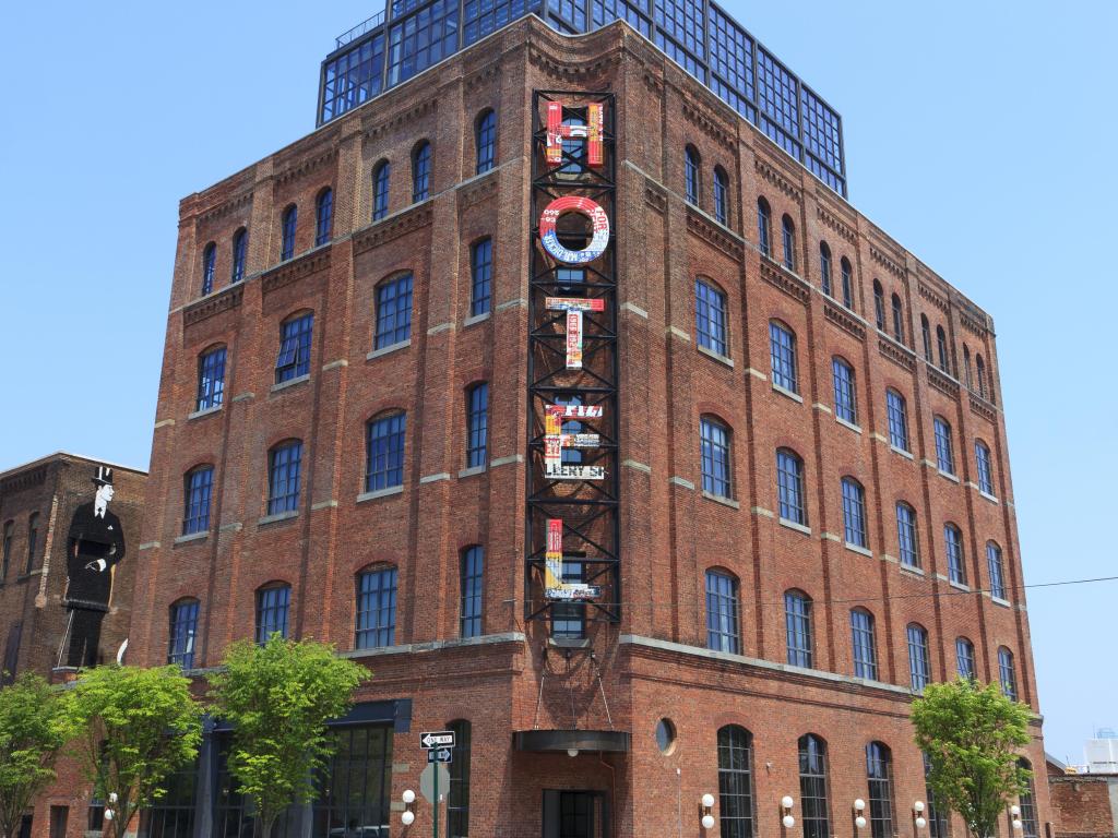 Front of historic factory now housing Wythe Hotel, New York City, with large lettering reading 'hotel' across the outside