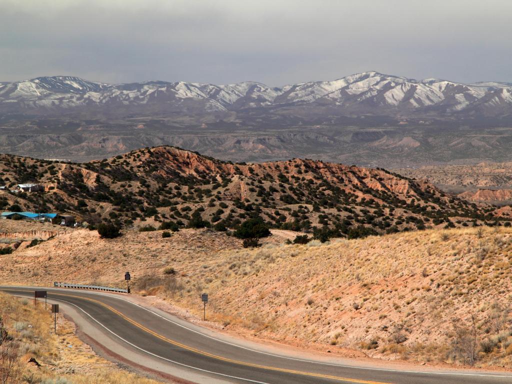 Taos, Northern New Mexico, USA with a view of the High Road to Taos, mountains and desert in the distance.