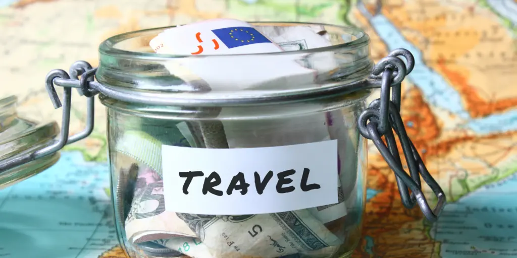 A pot filled with money labelled 'Travel'