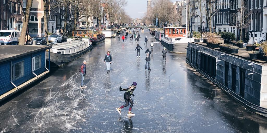 People ice skating on the frozen canal in Amsterdam 