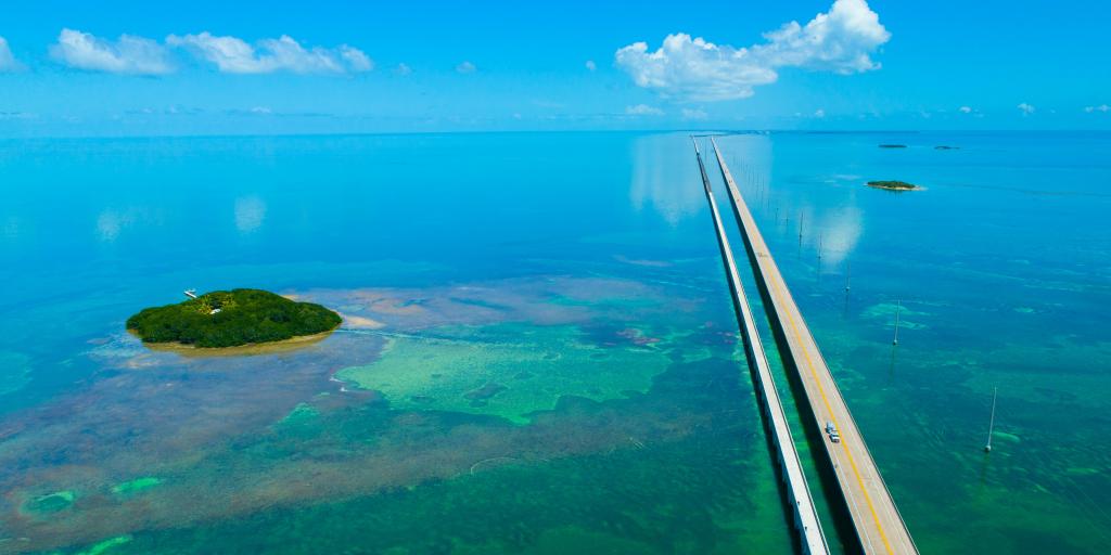 An aerial view of the straight 7 Seven Miles bridge on the Overseas Highway, Florida, with blue waters and reefs visible below the water