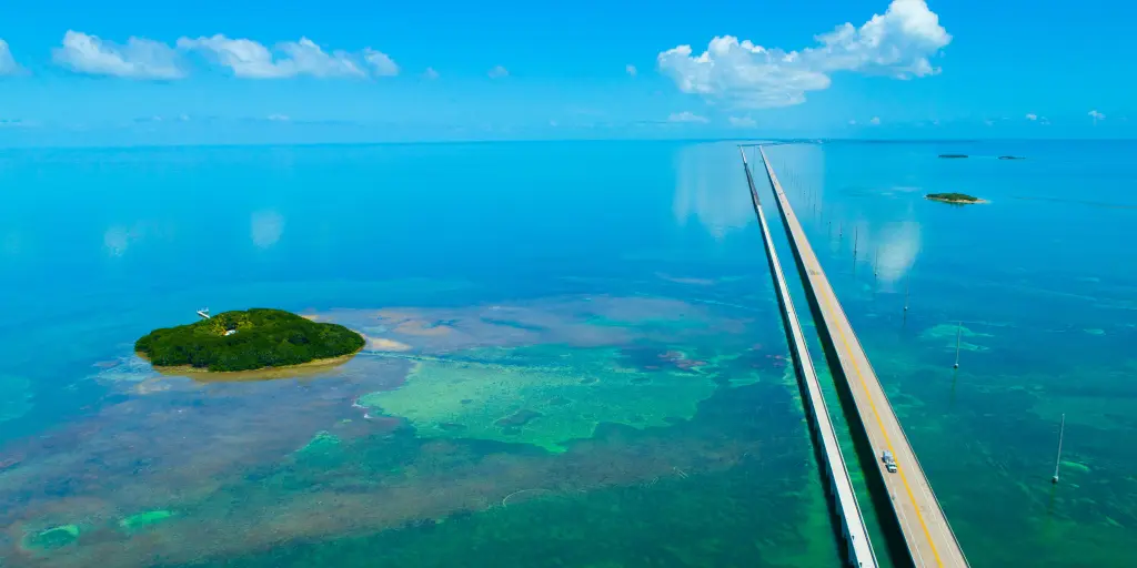 An aerial view of the straight 7 Seven Miles bridge on the Overseas Highway, Florida, with blue waters and reefs visible below the water