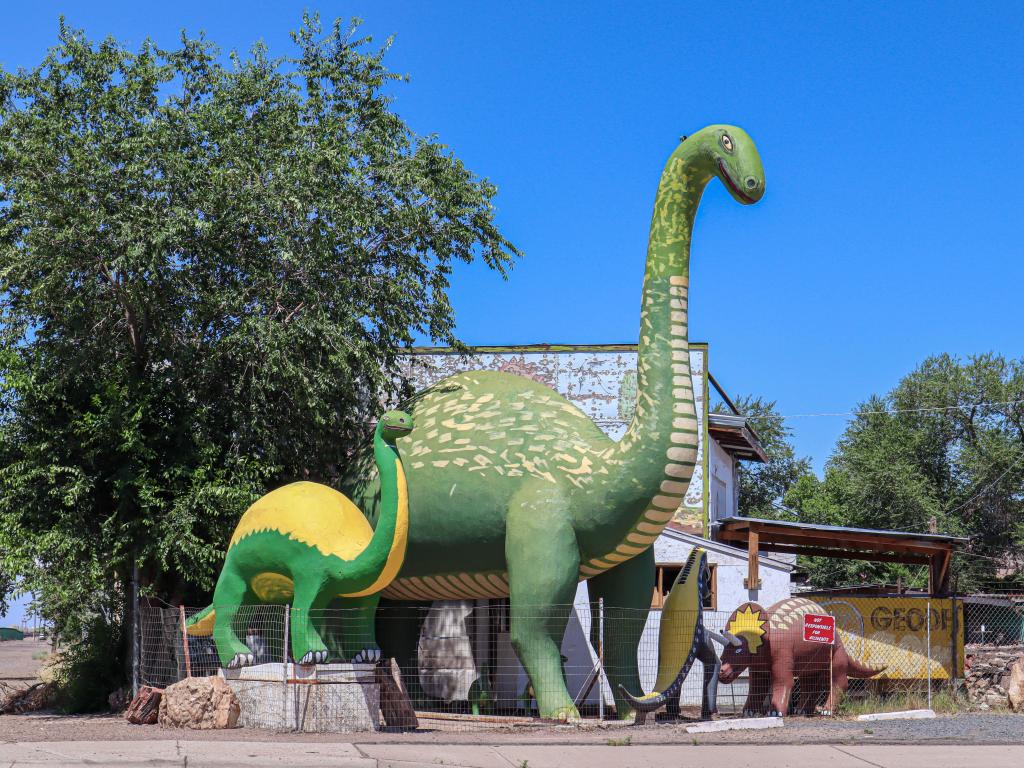 Big green dinosaur statues in Holbrook on a sunny day