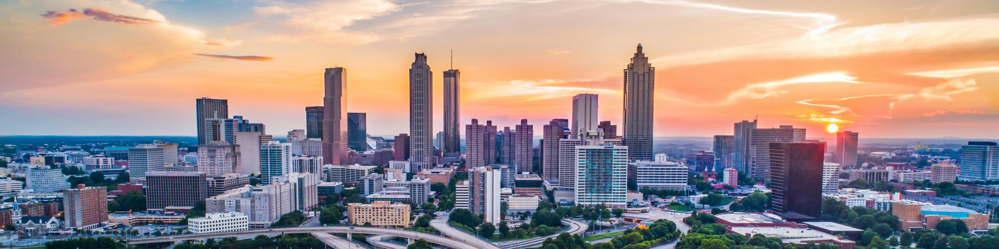 Atlanta, Georgia, USA with a panorama of the downtown skyline at sunset.