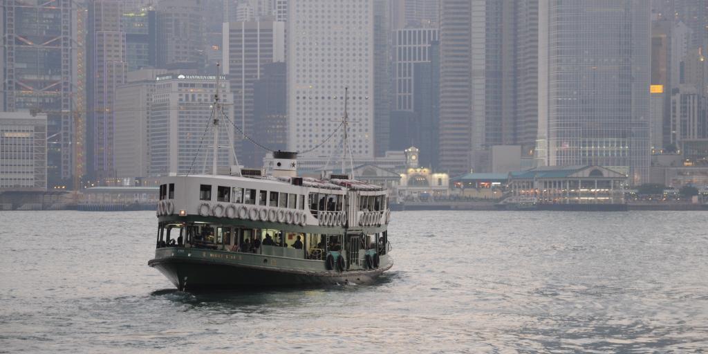 The Star Ferry crossing the harbour in Hong Kong with skyscrapers in the background