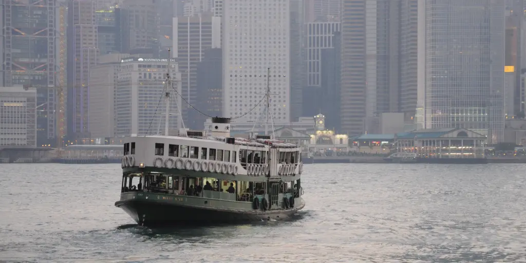 The Star Ferry crossing the harbour in Hong Kong with skyscrapers in the background