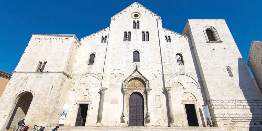 The outside of the Basilica di San Nicola, Bari against a blue sky 