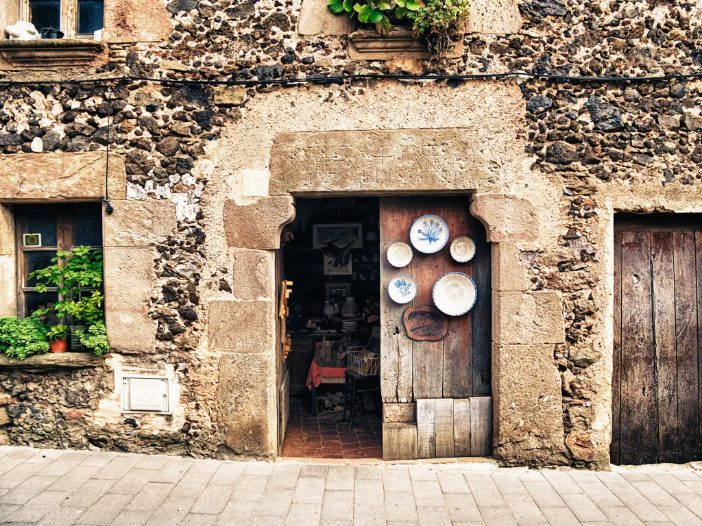 A traditional doorway with hanging plates in Santa Pau, Catalonia