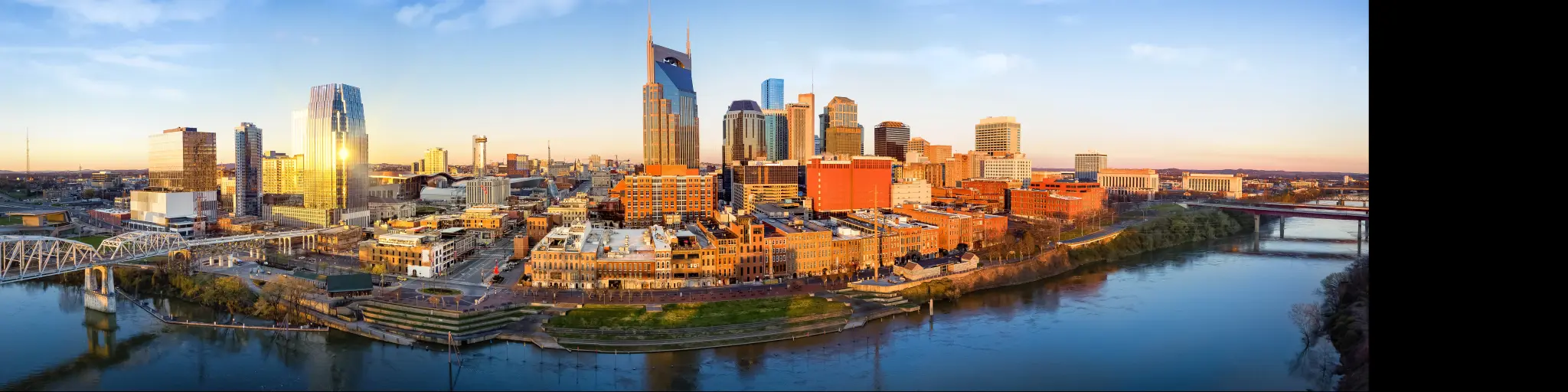 Nashville skyline at sunrise with the Cumberland River passing Downtown