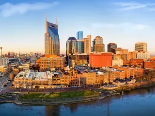 Nashville skyline at sunrise with the Cumberland River passing Downtown