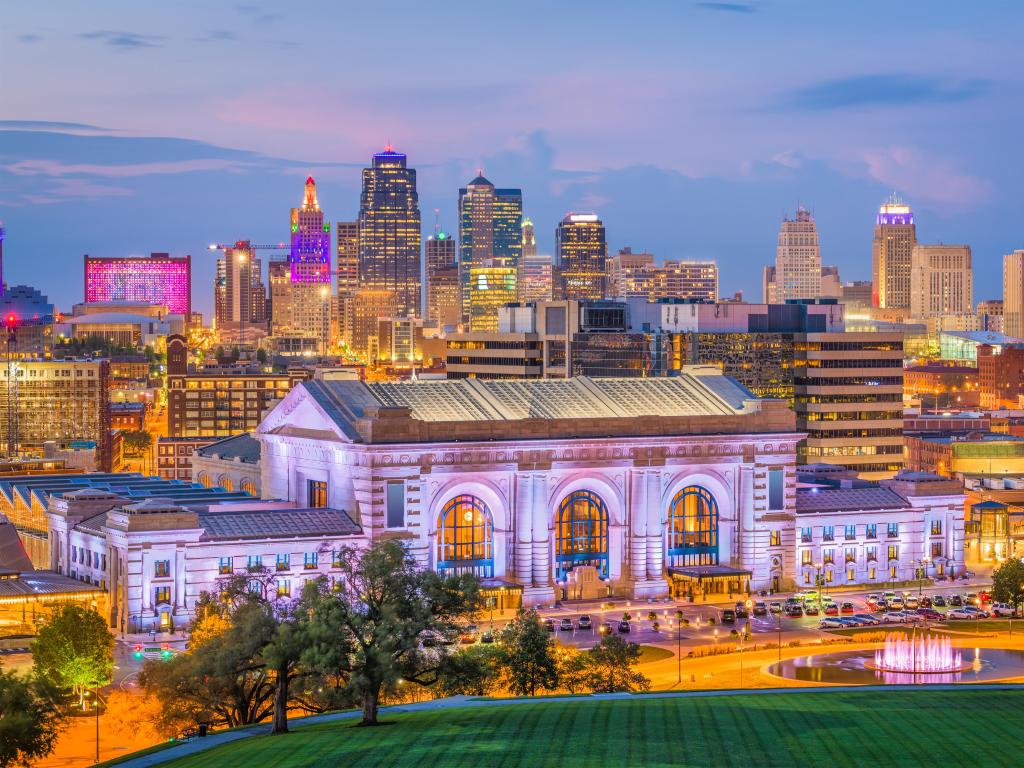 Kansas City, Missouri, USA downtown skyline with Union Station at dusk.