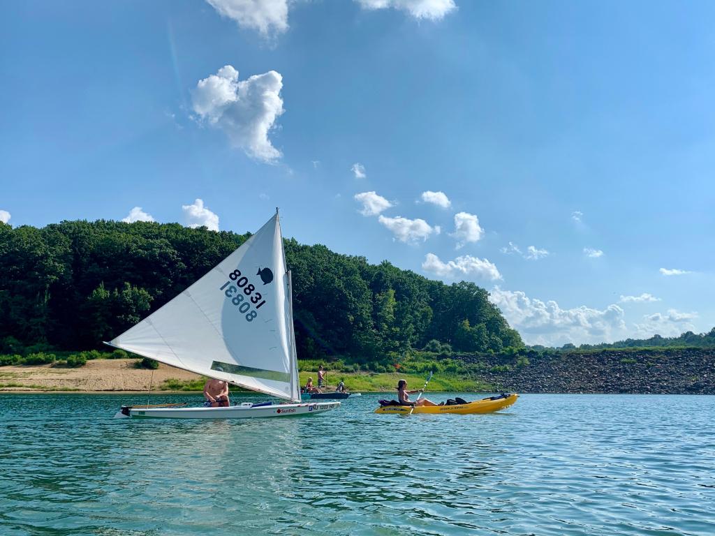 Sailboat and a kayak on the Round Valley Reservoir known for its pristine clear blue waters, New Jersey