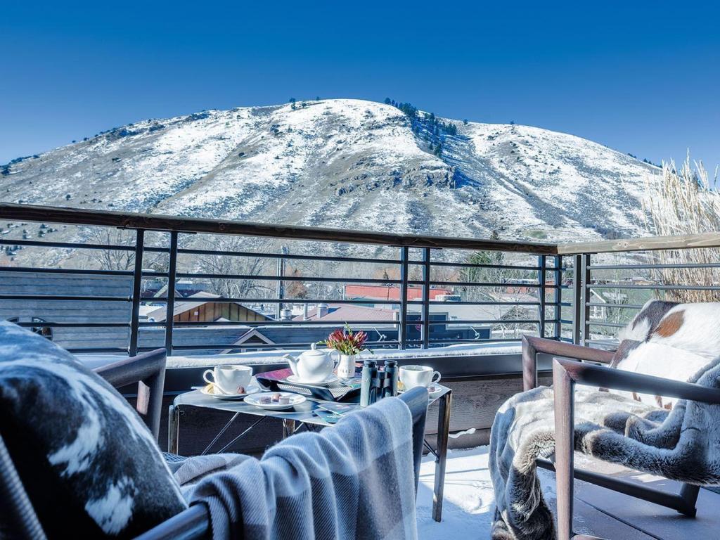 Views of luxury loungers on Hotel Jackson terrace overlooking snowy peaks of Jackson Hole 