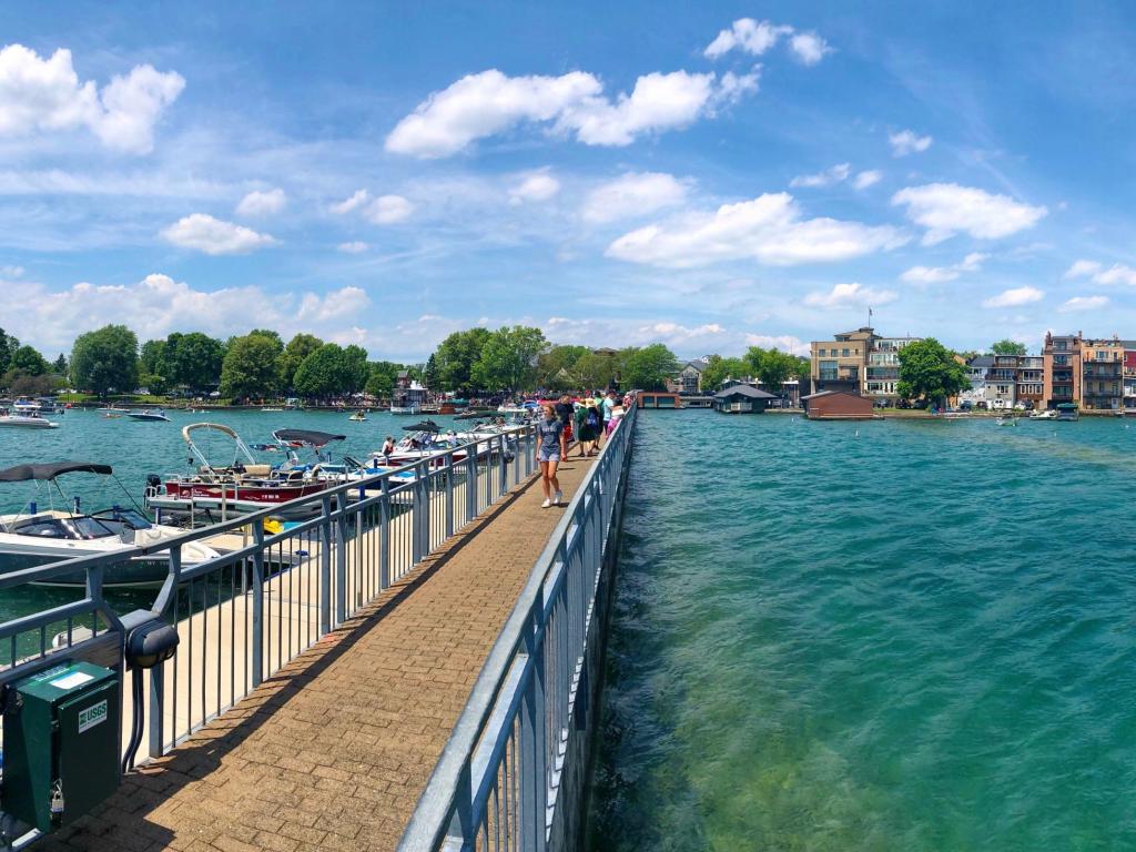 Panoramic view of the pier, boats and lakeshore scenery in the Skaneateles Lake, New York