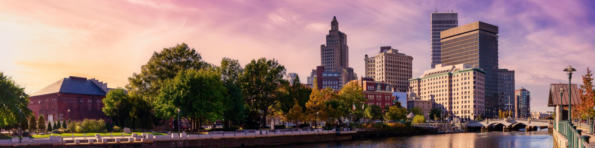 Providence, Rhode Island, USA with a panoramic view of a modern downtown city skyline on the Atlantic Ocean East Coast and a colorful sunset.