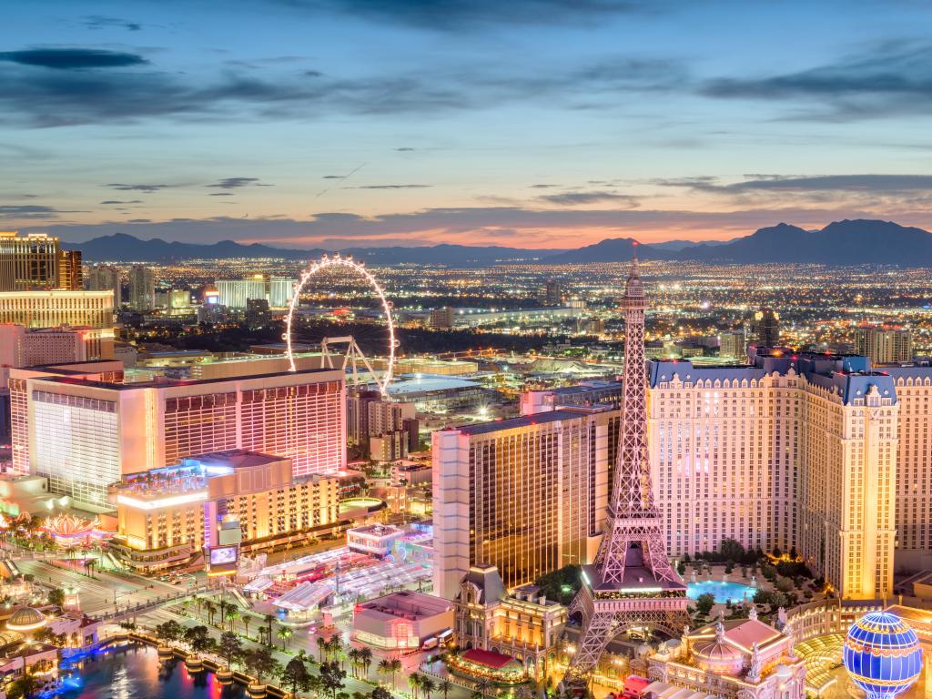 Las Vegas, Nevada showing the famous strip at dusk and in the distance the mountain terrain.