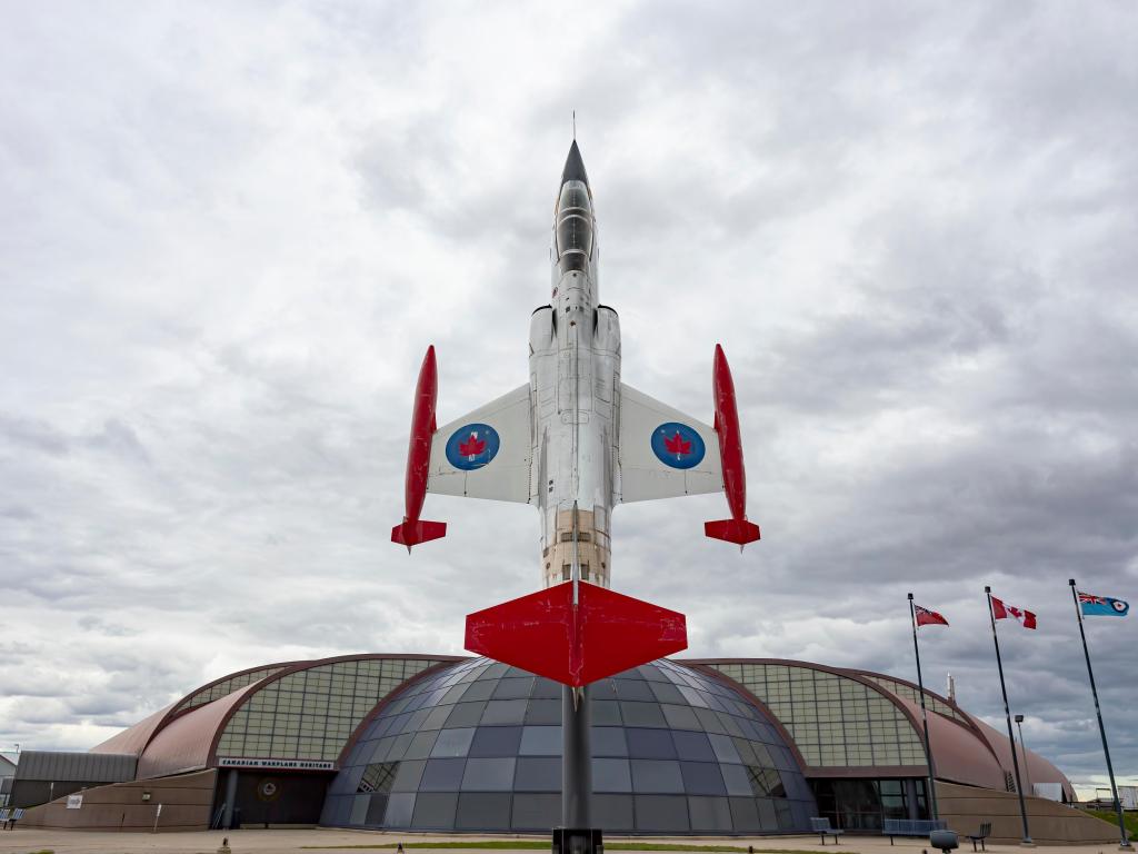 A fighter jet, arranged as if it going vertically up at the entrance of the museum
