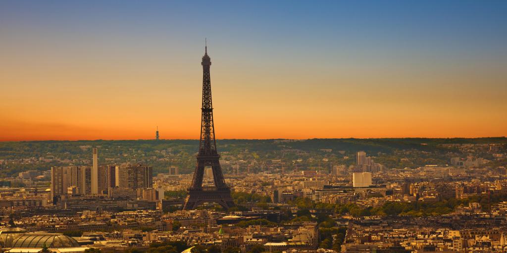 A view from Montmartre of the sun setting behind the Eiffel Tower in Paris