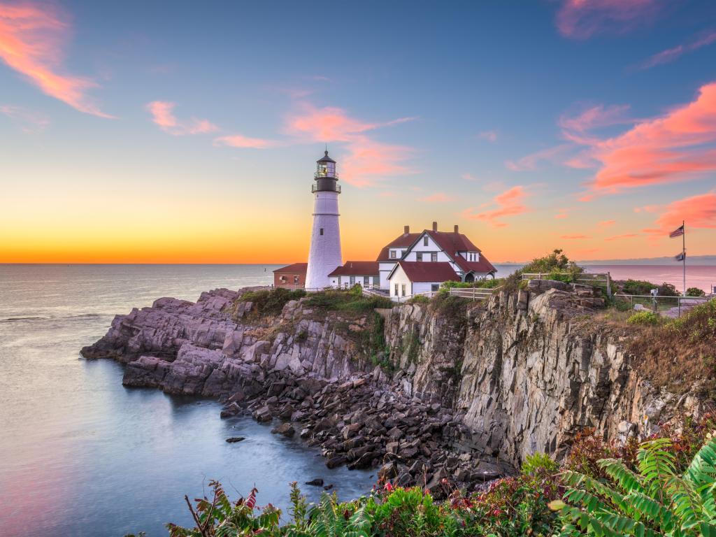 Portland Head Light in Maine at sunset with pink clouds in the sky