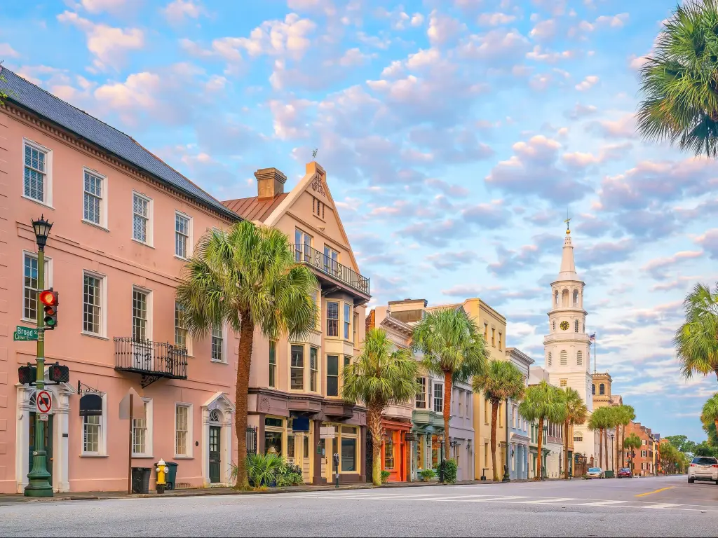 Charleston, South Carolina, USA with a pretty street scene lined with palm trees on a sunny day.