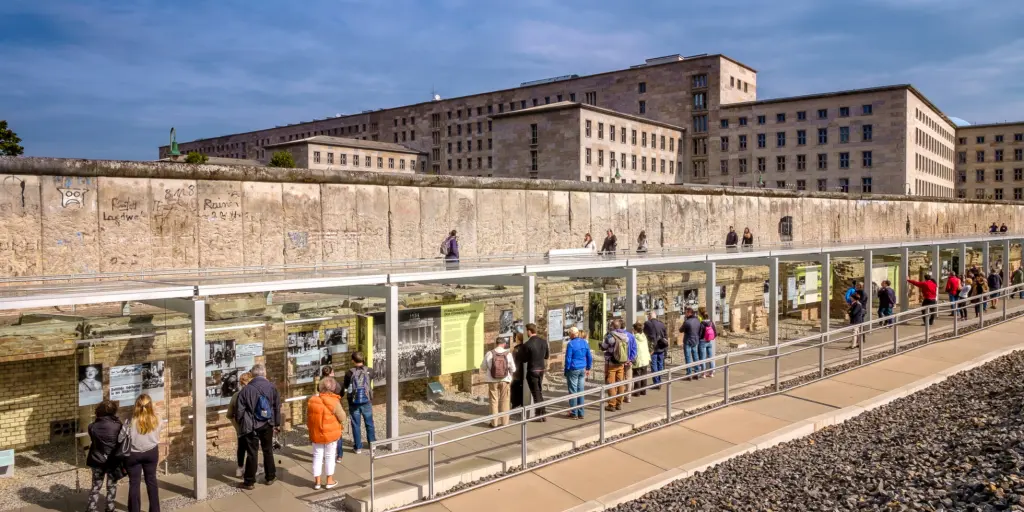 People viewing the Berlin Wall remains and the museum and documentation centre at the Topography of Terror Foundation