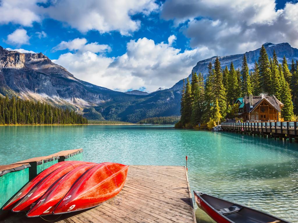 Brilliant red kayaks dry upside down. Emerald Lake in Canadian Rockies. 