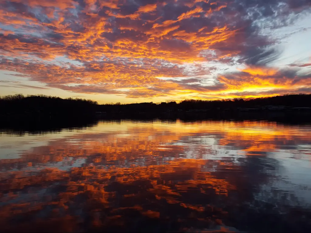 Vivid orange sunset reflecting on the waters of Smith Mountain Lake in Virginia