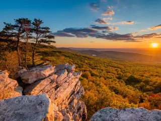 Sunset view from Annapolis Rocks, along the Appalachian Trail in Maryland with forests on rolling hills in the background