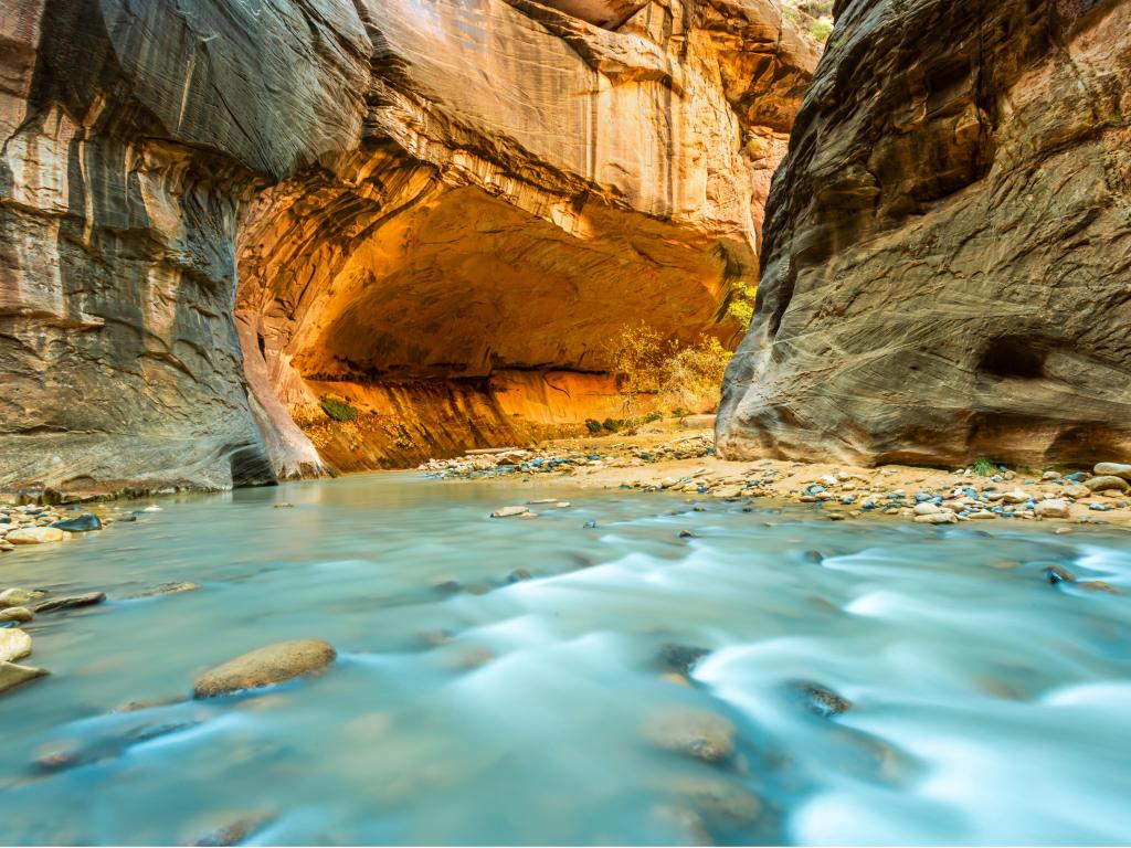 Turquoise river runs through steep sided red rock gorge