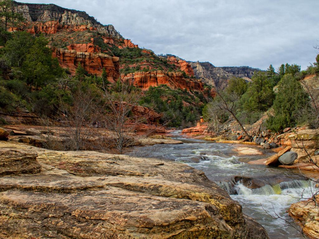 Sedona, Arizona, USA taken at early evening with a river, rocks and trees in the distance.