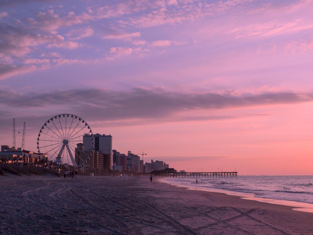 Myrtle Beach, South Caroline, USA taken at sunrise with the beach and ocean and pier in the distance with a stunning sky.