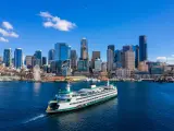Aerial shot of a ferry approaching Seattle on a sunny day