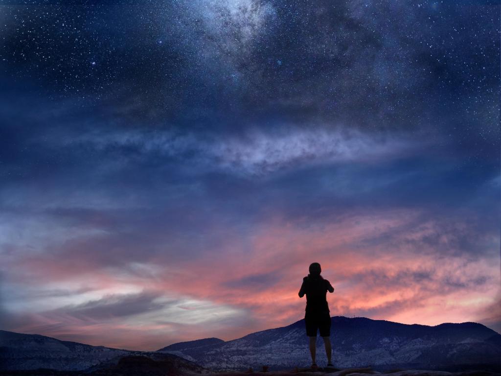 Torrey, Utah. Milky Way over desert landscape with hiker