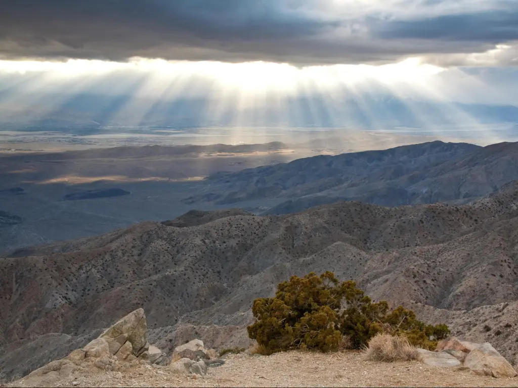 Keys View, Joshua Tree National Park, USA taken at sunset with a view of the mountains in the distance against a cloudy sky.