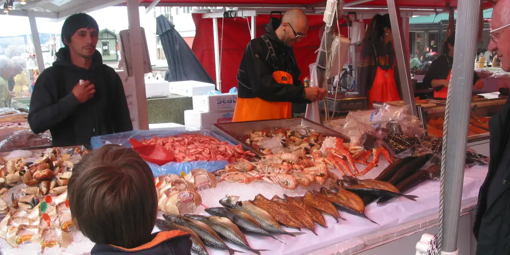 A boy and a man peruse the offerings at Bergen's famous fish market in Norway