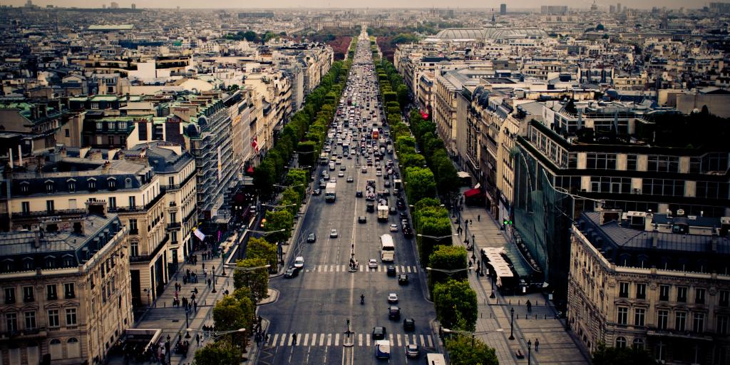 Cars driving along the tree-lined Champs Elysees in Paris, France