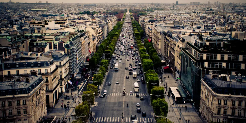Cars driving along the tree-lined Champs Elysees in Paris, France